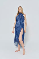 Pregnant woman wearing a Bumpsuit & Spell blue scarf as a  dress on a white background
