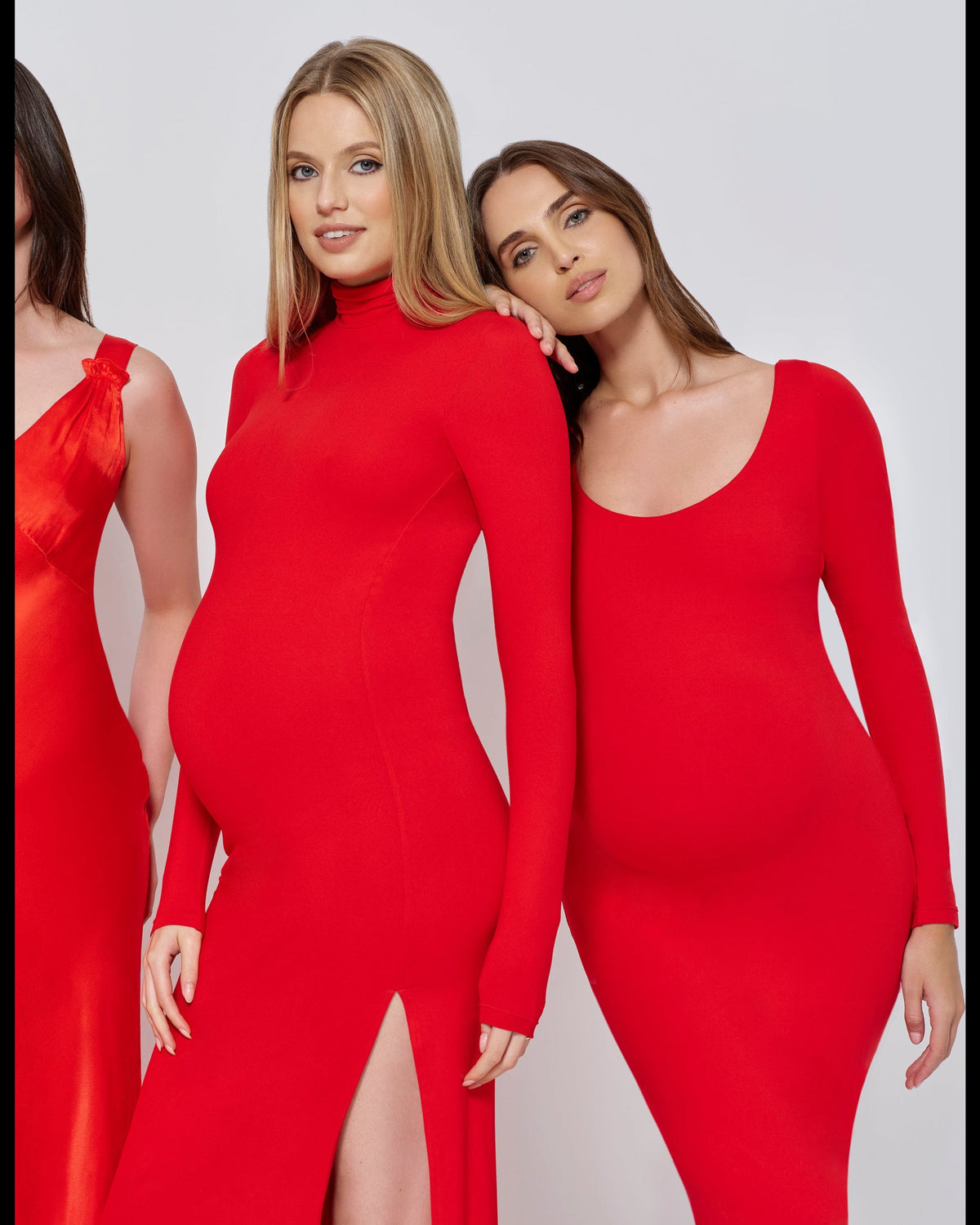 Four women wearing red dresses on a white background