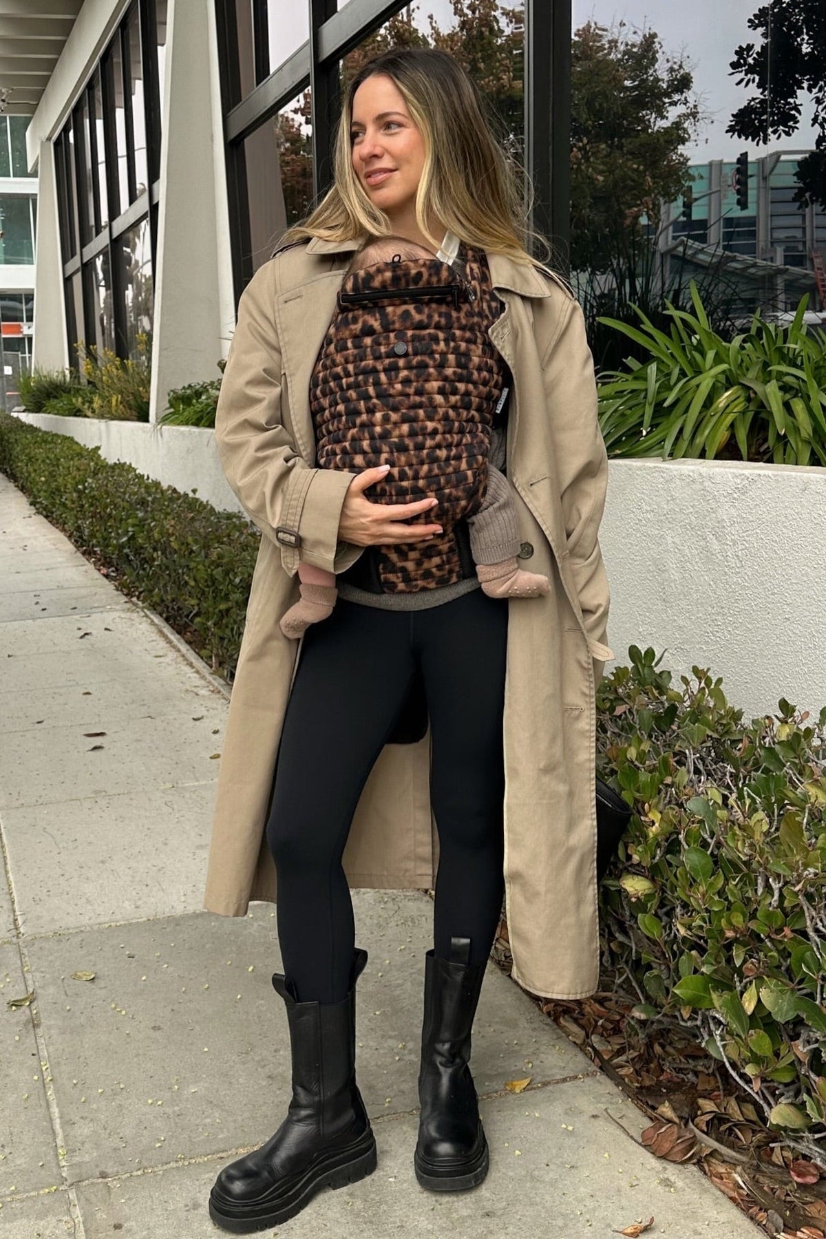 woman with baby in the armadillo leopard print baby carrier