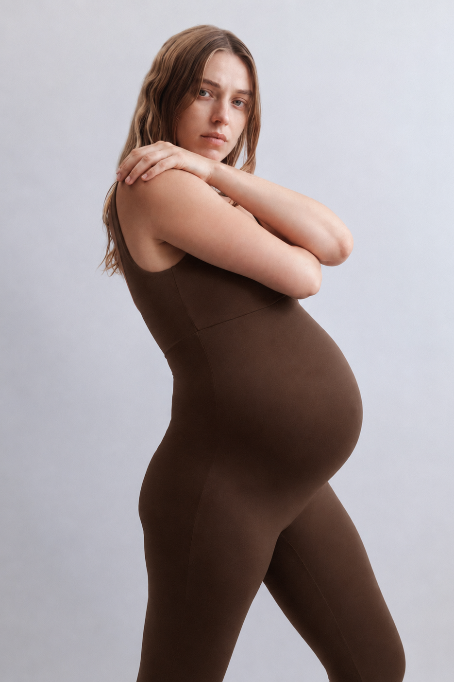 Woman wearing a Bumpsuit Chocolate brown bodysuit against a plain background