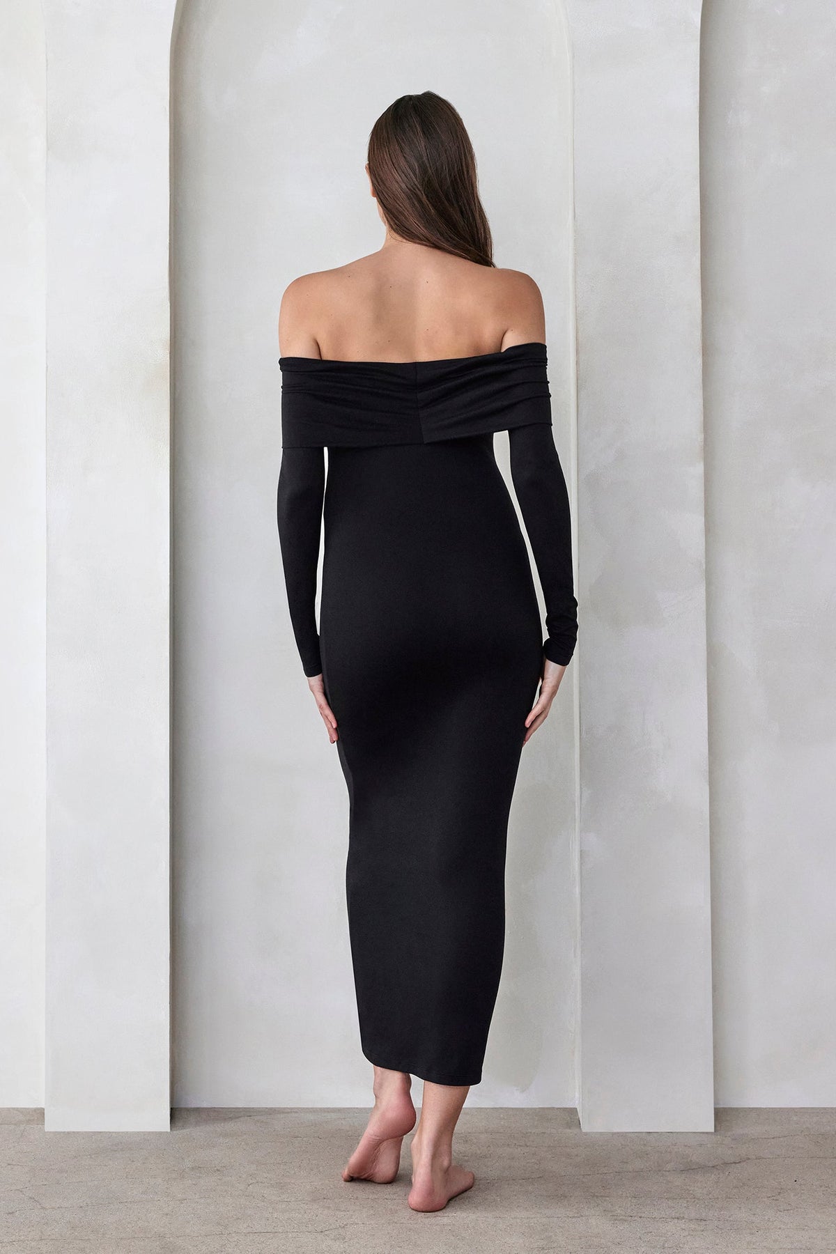 Woman wearing the black off the shoulder Alison dress