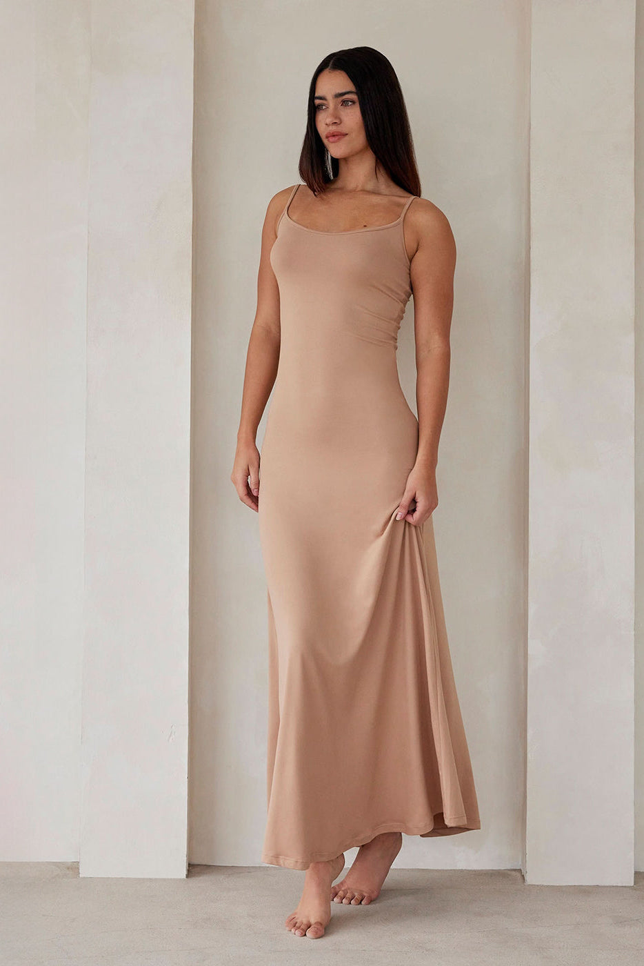 Front view of the oat Cloud Maxi Dress showcasing its scoop neckline and thin straps on a model in a neutral indoor setting