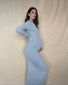 side view of pregnant woman wearing a bumpsuit soft rib maxi dress